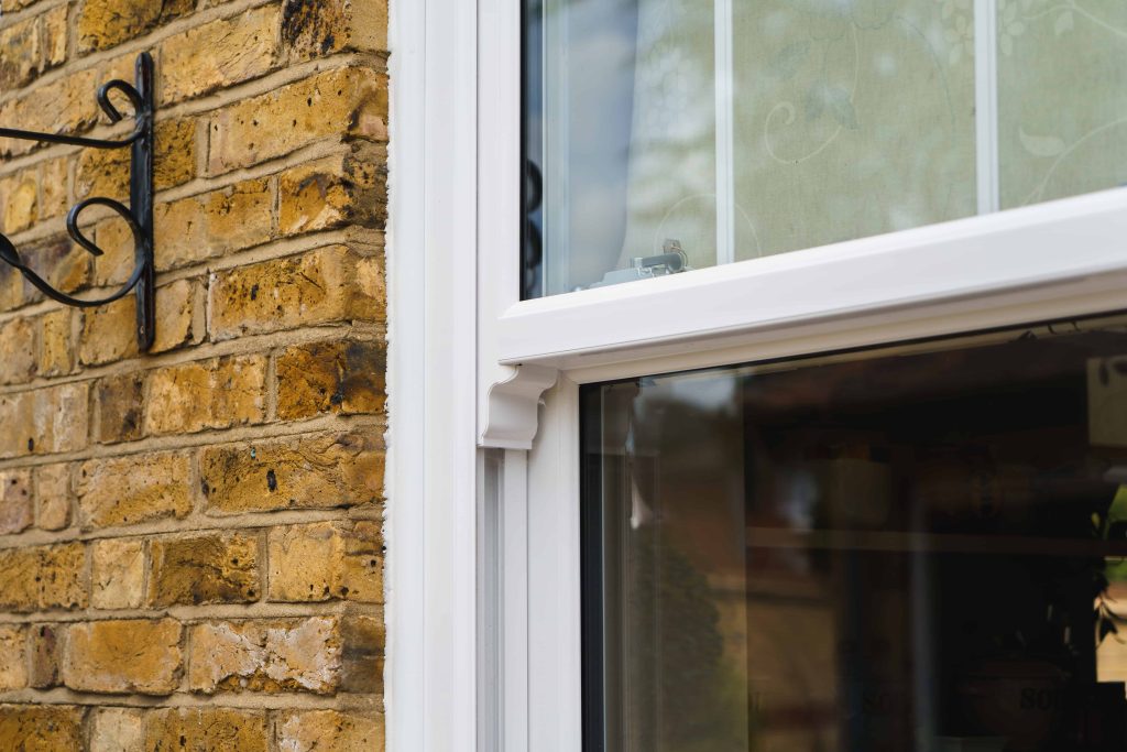 Why choose made-to-measure uPVC windows? 2 ECOSlide vertical sliding windows sit proudly on a traditional property in Hornchurch, UK. These windows are white.